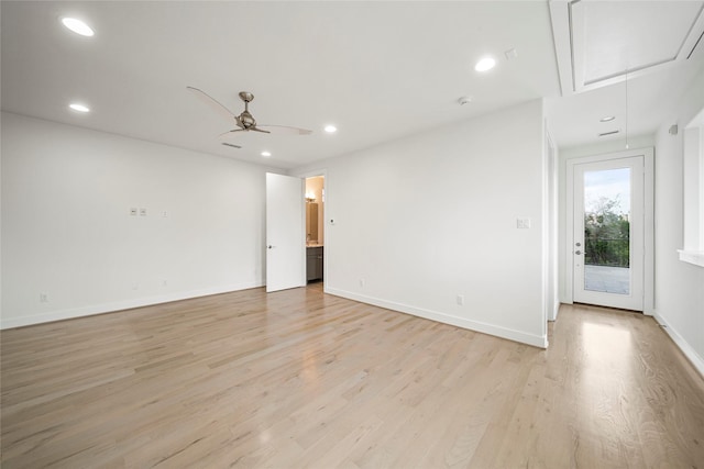 empty room featuring attic access, light wood-type flooring, recessed lighting, a ceiling fan, and baseboards