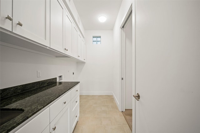 bar with baseboards and a sink