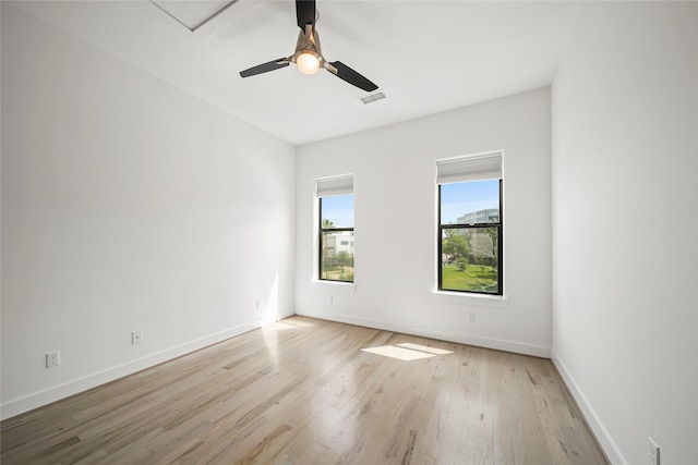 unfurnished room with light wood-type flooring, baseboards, and a ceiling fan