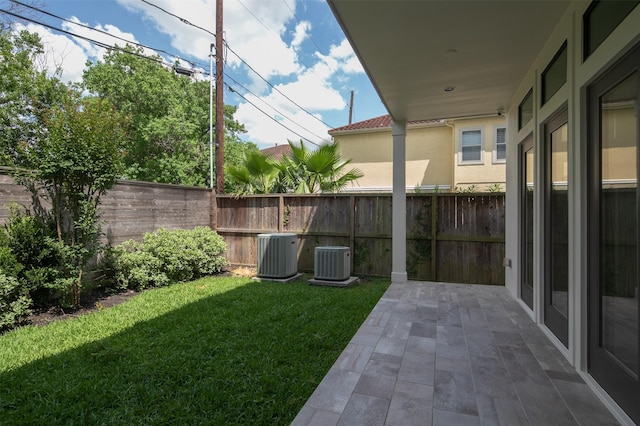 view of yard with central AC and a patio area