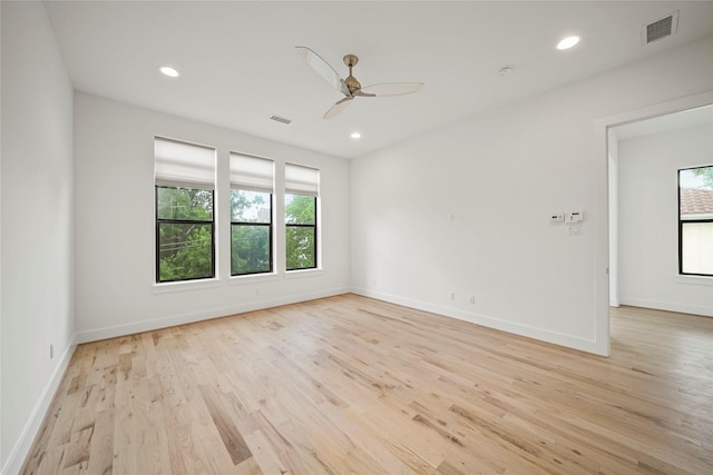 spare room with healthy amount of natural light, light wood-style floors, ceiling fan, and recessed lighting