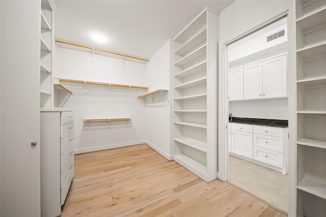 walk in closet featuring light wood-type flooring