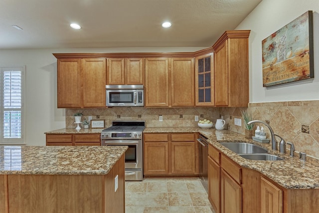 71 Ginger Jar St, The Woodlands, TX 77382 - kitchen featuring stainless steel appliances, a sink, light stone counters, decorative backsplash, and recessed lighting