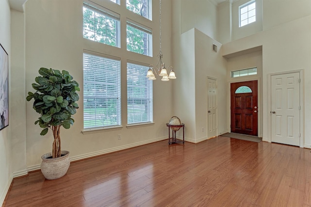 71 Ginger Jar St, The Woodlands, TX 77382 - entrance foyer with wood finished floors, a towering ceiling, a chandelier, and baseboards