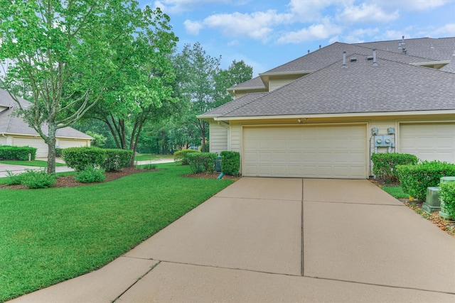 71 Ginger Jar St, The Woodlands, TX 77382 - view of side of home featuring a shingled roof, a lawn, concrete driveway, and an attached garage