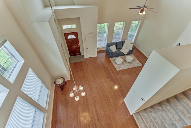 71 Ginger Jar St, The Woodlands, TX 77382 - entrance foyer with a towering ceiling, wood finished floors, a ceiling fan, and baseboards