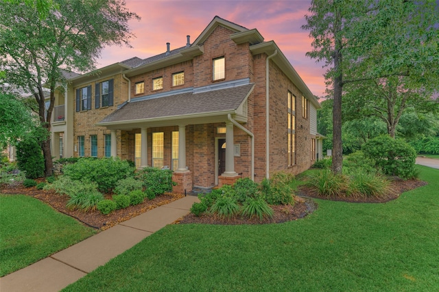 71 Ginger Jar St, The Woodlands, TX 77382 - view of front of property with brick siding, a front yard, and covered porch
