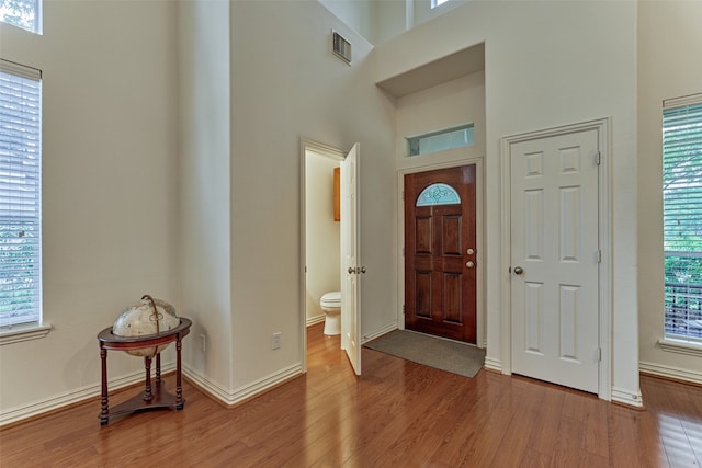 71 Ginger Jar St, The Woodlands, TX 77382 - foyer entrance with wood finished floors, a high ceiling, and baseboards