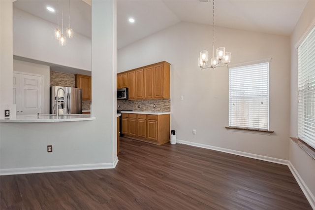 18314 Madisons Crossing Ln, Tomball, TX 77375 - kitchen with a chandelier, appliances with stainless steel finishes, dark wood finished floors, brown cabinets, and high vaulted ceiling