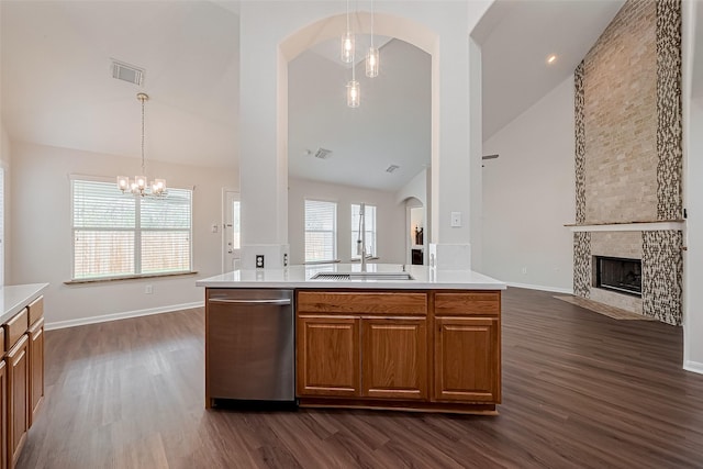18314 Madisons Crossing Ln, Tomball, TX 77375 - kitchen featuring a sink, dishwasher, open floor plan, dark wood finished floors, and brown cabinets