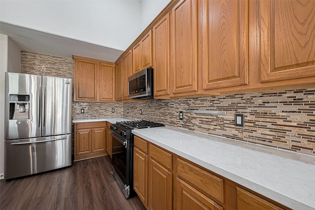 18314 Madisons Crossing Ln, Tomball, TX 77375 - kitchen featuring appliances with stainless steel finishes, dark wood-type flooring, backsplash, brown cabinets, and light stone counters