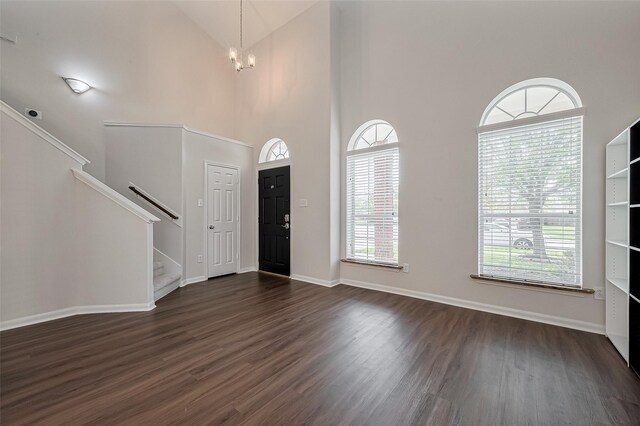 18314 Madisons Crossing Ln, Tomball, TX 77375 - entryway with dark wood finished floors, stairway, a chandelier, baseboards, and high vaulted ceiling