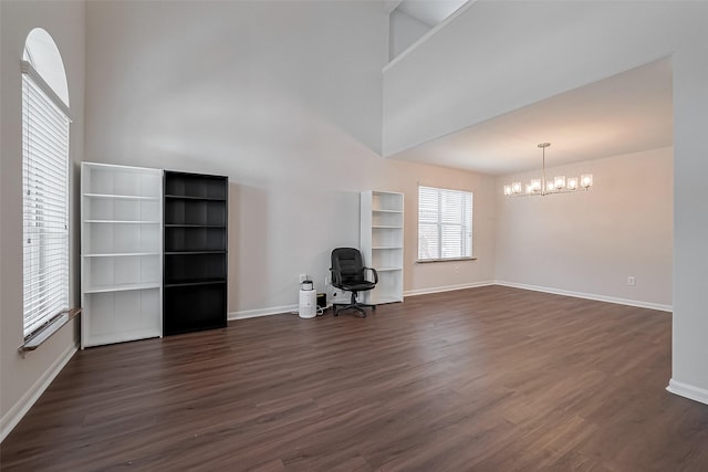 18314 Madisons Crossing Ln, Tomball, TX 77375 - unfurnished living room featuring a chandelier, dark wood finished floors, baseboards, and a high ceiling