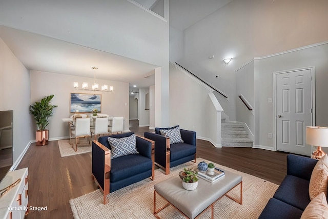 18314 Madisons Crossing Ln, Tomball, TX 77375 - living room with wood finished floors, a chandelier, stairs, baseboards, and a towering ceiling