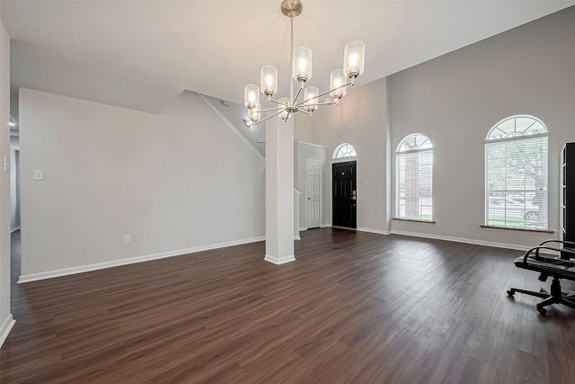 18314 Madisons Crossing Ln, Tomball, TX 77375 - unfurnished living room featuring dark wood-style floors, baseboards, a chandelier, and a high ceiling