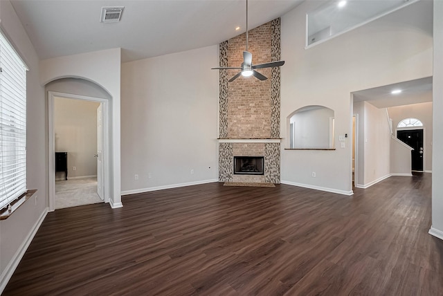 18314 Madisons Crossing Ln, Tomball, TX 77375 - unfurnished living room featuring a ceiling fan, high vaulted ceiling, dark wood-type flooring, a large fireplace, and baseboards