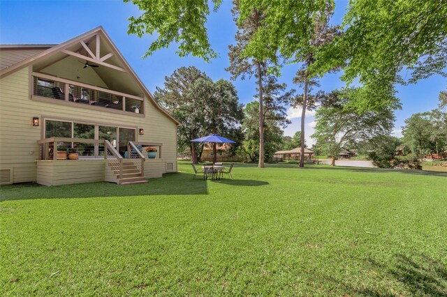 16 Wildwood Lake Dr, Huntsville, TX 77340 - back of property with a balcony and a yard