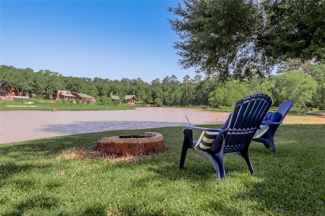 16 Wildwood Lake Dr, Huntsville, TX 77340 - view of home's community with a water view, a yard, and an outdoor fire pit