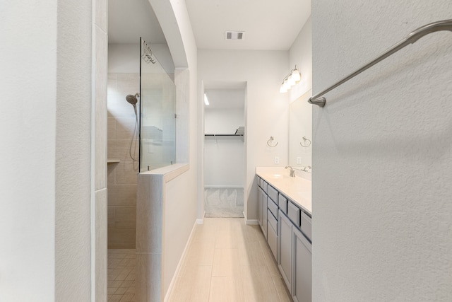 2715 Chestnut Oak Cir, Brookshire, TX 77494 - bathroom with a walk in shower, vanity, a spacious closet, tile patterned floors, and baseboards