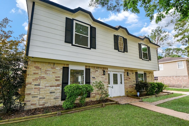 4719 Theall Rd, Houston, TX 77066 - view of front of house with a front yard and brick siding