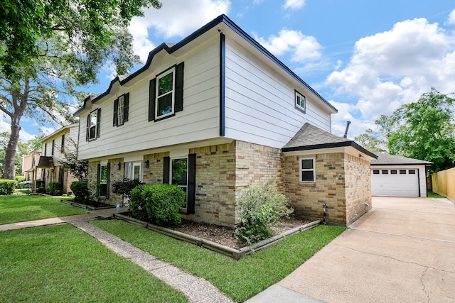 4719 Theall Rd, Houston, TX 77066 - view of front of house with brick siding, a garage, an outbuilding, a front lawn, and a shingled roof