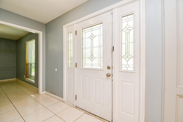 4719 Theall Rd, Houston, TX 77066 - entrance foyer with light tile patterned floors, healthy amount of natural light, and baseboards