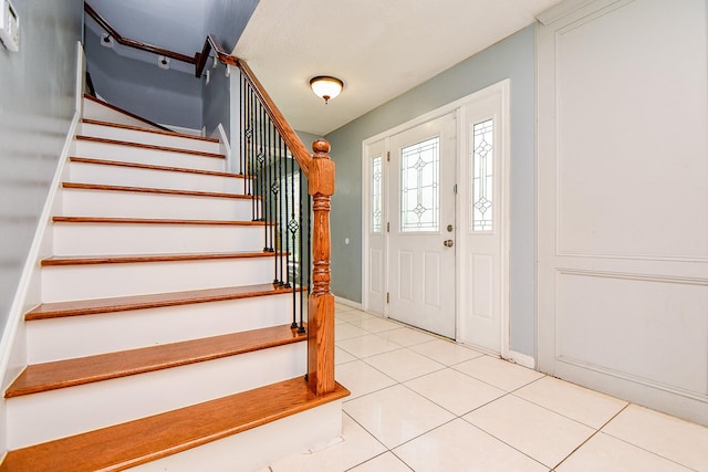 4719 Theall Rd, Houston, TX 77066 - entryway with stairway, light tile patterned floors, and baseboards