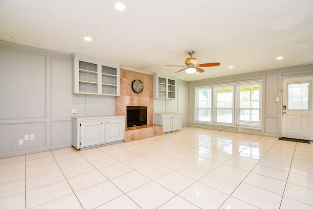 4719 Theall Rd, Houston, TX 77066 - unfurnished living room with a decorative wall, a ceiling fan, a fireplace, light tile patterned flooring, and recessed lighting
