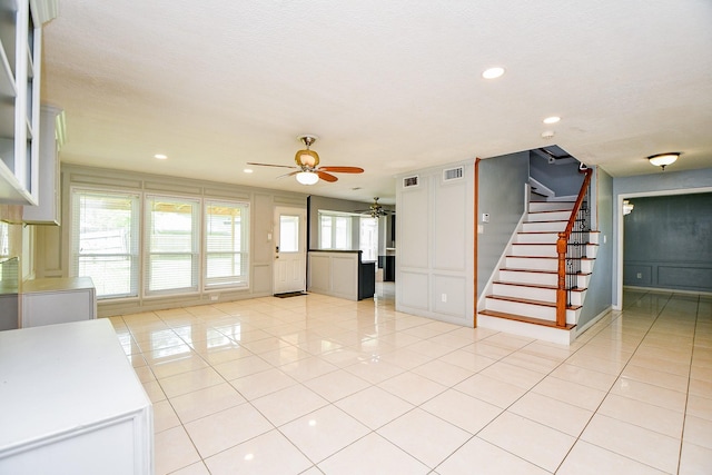 4719 Theall Rd, Houston, TX 77066 - unfurnished living room featuring ceiling fan, stairs, light tile patterned floors, and recessed lighting