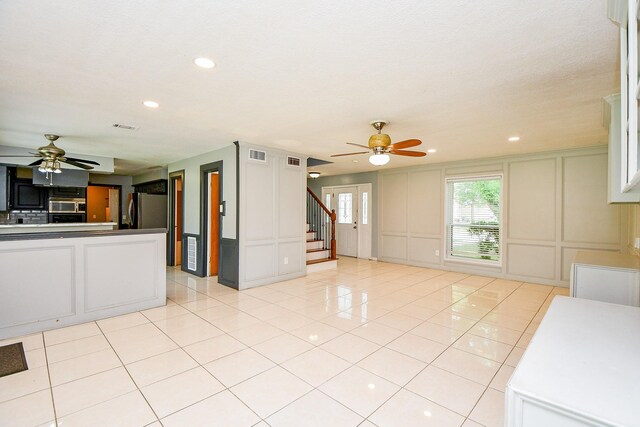4719 Theall Rd, Houston, TX 77066 - kitchen featuring a decorative wall, ceiling fan, refrigerator, recessed lighting, and light tile patterned flooring