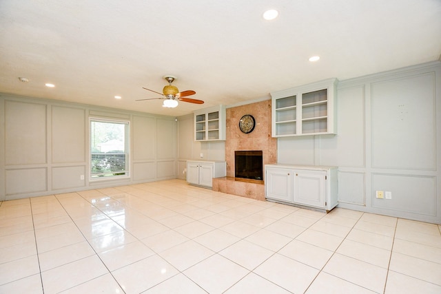 4719 Theall Rd, Houston, TX 77066 - unfurnished living room featuring a decorative wall, ceiling fan, a fireplace, recessed lighting, and light tile patterned floors