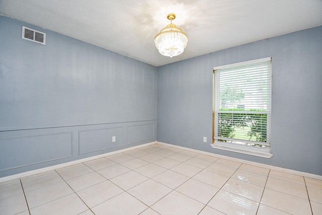 4719 Theall Rd, Houston, TX 77066 - spare room featuring a chandelier and light tile patterned floors