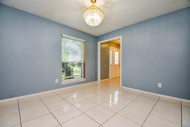 4719 Theall Rd, Houston, TX 77066 - unfurnished room with a chandelier, light tile patterned floors, and baseboards