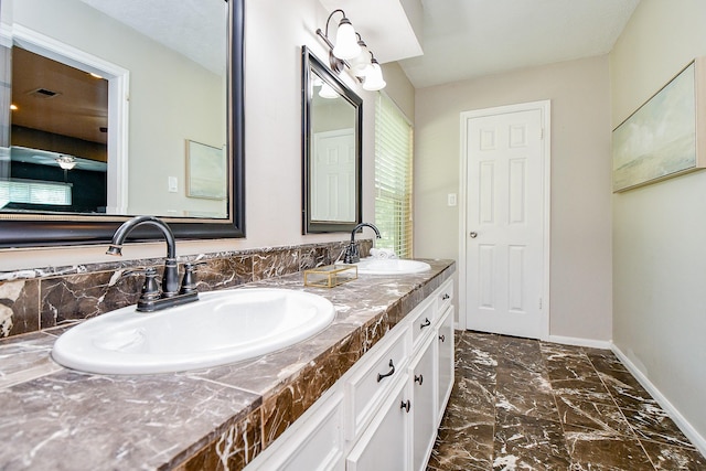 4719 Theall Rd, Houston, TX 77066 - bathroom featuring double vanity, baseboards, and marble finish flooring