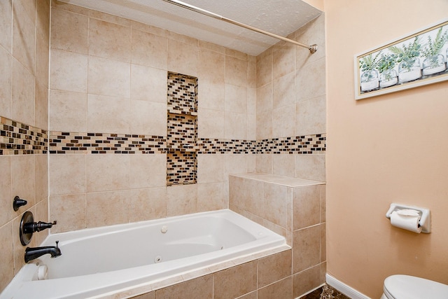 4719 Theall Rd, Houston, TX 77066 - bathroom with baseboards, toilet, and tiled shower / bath