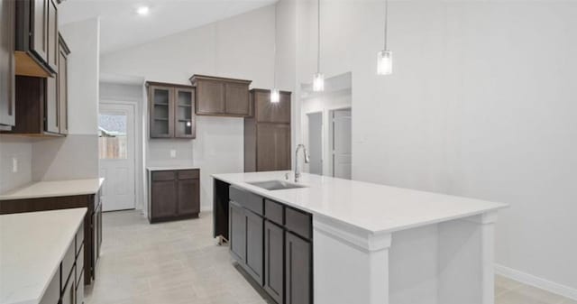 21519 Cypress Trellis Dr, Cypress, TX 77433 - kitchen with a sink, an island with sink, light countertops, glass insert cabinets, and pendant lighting