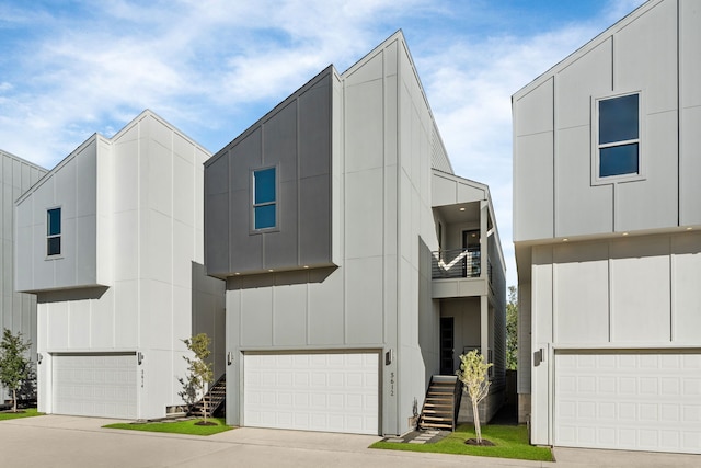 5609 Savyon Dr, Houston, TX 77091 - contemporary home featuring an attached garage, board and batten siding, a balcony, and stairs