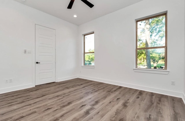 5609 Savyon Dr, Houston, TX 77091 - empty room with healthy amount of natural light, ceiling fan, baseboards, wood finished floors, and recessed lighting