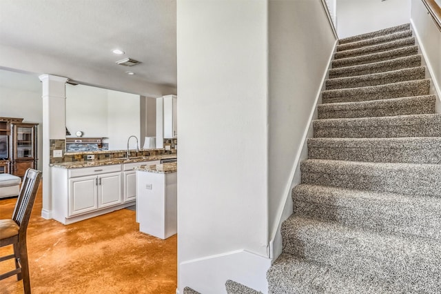 6207 Presidio Canyon Dr, Katy, TX 77450 - stairs featuring baseboards, recessed lighting, and decorative columns