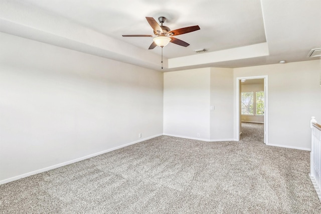 6207 Presidio Canyon Dr, Katy, TX 77450 - unfurnished room with ceiling fan, carpet flooring, a tray ceiling, baseboards, and attic access