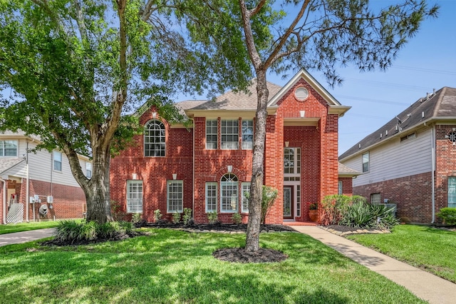 6207 Presidio Canyon Dr, Katy, TX 77450 - georgian-style home featuring brick siding and a front yard