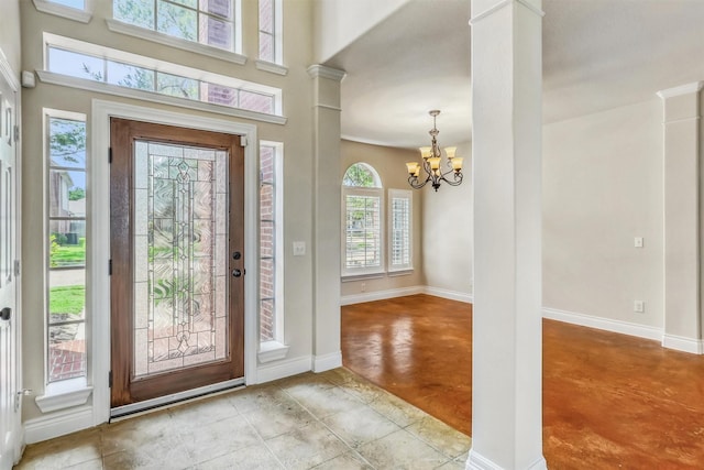 6207 Presidio Canyon Dr, Katy, TX 77450 - entryway featuring ornate columns, a chandelier, baseboards, and concrete flooring