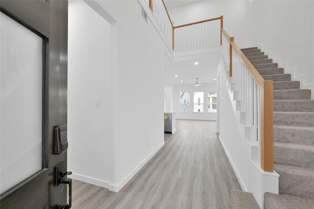 111 Capetown Way, Conroe, TX 77356 - entryway featuring stairs, wood finished floors, a towering ceiling, baseboards, and recessed lighting