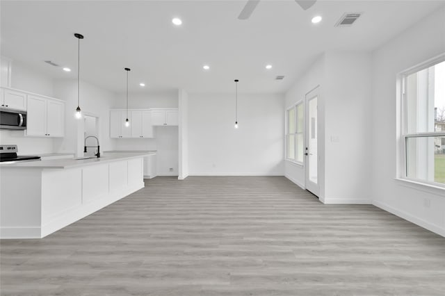 111 Capetown Way, Conroe, TX 77356 - kitchen with appliances with stainless steel finishes, ceiling fan, healthy amount of natural light, a sink, and recessed lighting