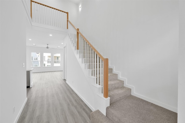 111 Capetown Way, Conroe, TX 77356 - staircase with baseboards, ceiling fan, wood finished floors, recessed lighting, and a high ceiling
