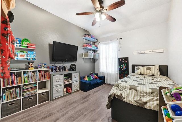 2201 Piney Wood Dr, Deer Park, TX 77536 - bedroom with wood finished floors, vaulted ceiling, and a ceiling fan