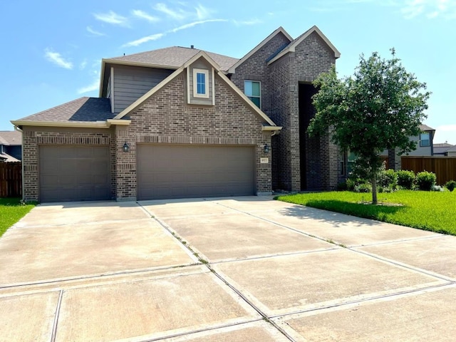 4923 Lacebark Pine Trl, Rosenberg, TX 77471 - traditional-style home featuring brick siding, a garage, driveway, and a front lawn