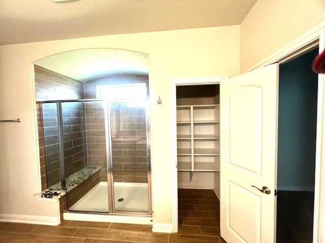 4923 Lacebark Pine Trl, Rosenberg, TX 77471 - bathroom with wood finish floors, a shower stall, baseboards, and a walk in closet
