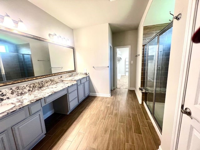 4923 Lacebark Pine Trl, Rosenberg, TX 77471 - bathroom featuring a shower stall, wood finished floors, double vanity, and baseboards