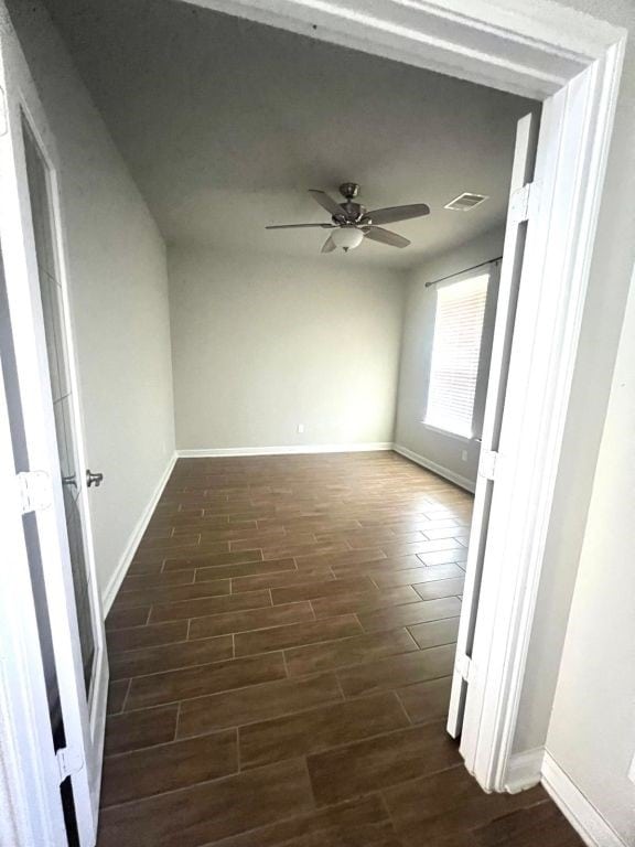 4923 Lacebark Pine Trl, Rosenberg, TX 77471 - empty room featuring dark wood finished floors, baseboards, and ceiling fan
